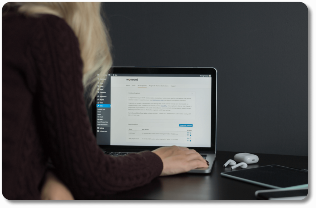 A person sitting at a desk with a laptop, focusing on copywriting, content writing, content planning, proofreading