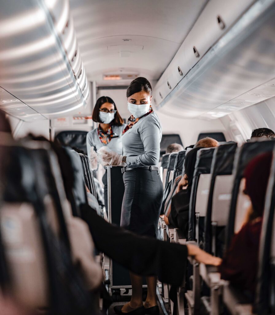 Flight attendants assisting passengers during air travel