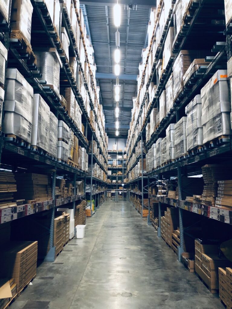 Warehouse stacking systems on pallets in a manufacturing building