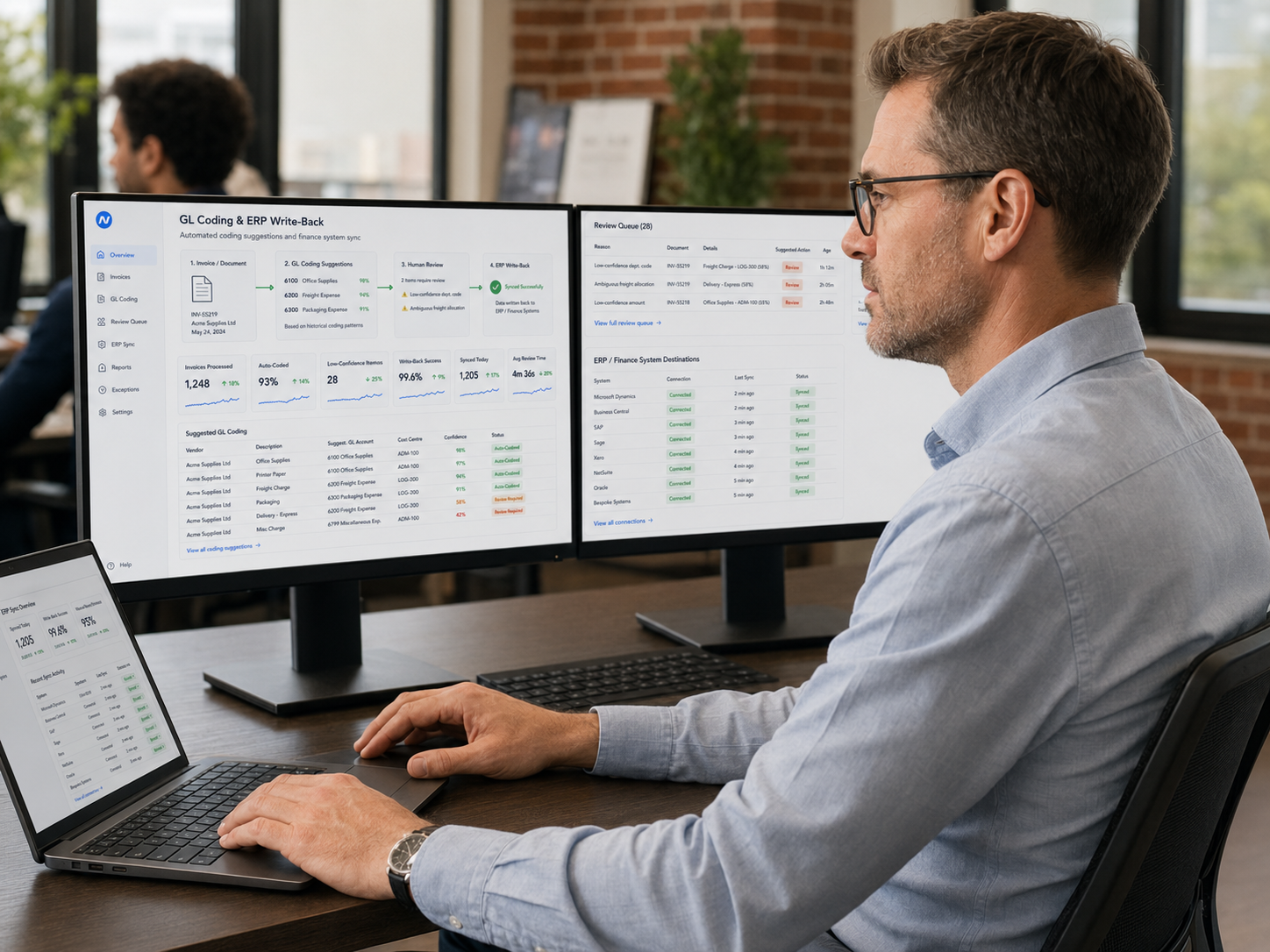 Finance professional working at desktop screens configured with GL coding and ERP write-back interfaces for automated accounts payable processing